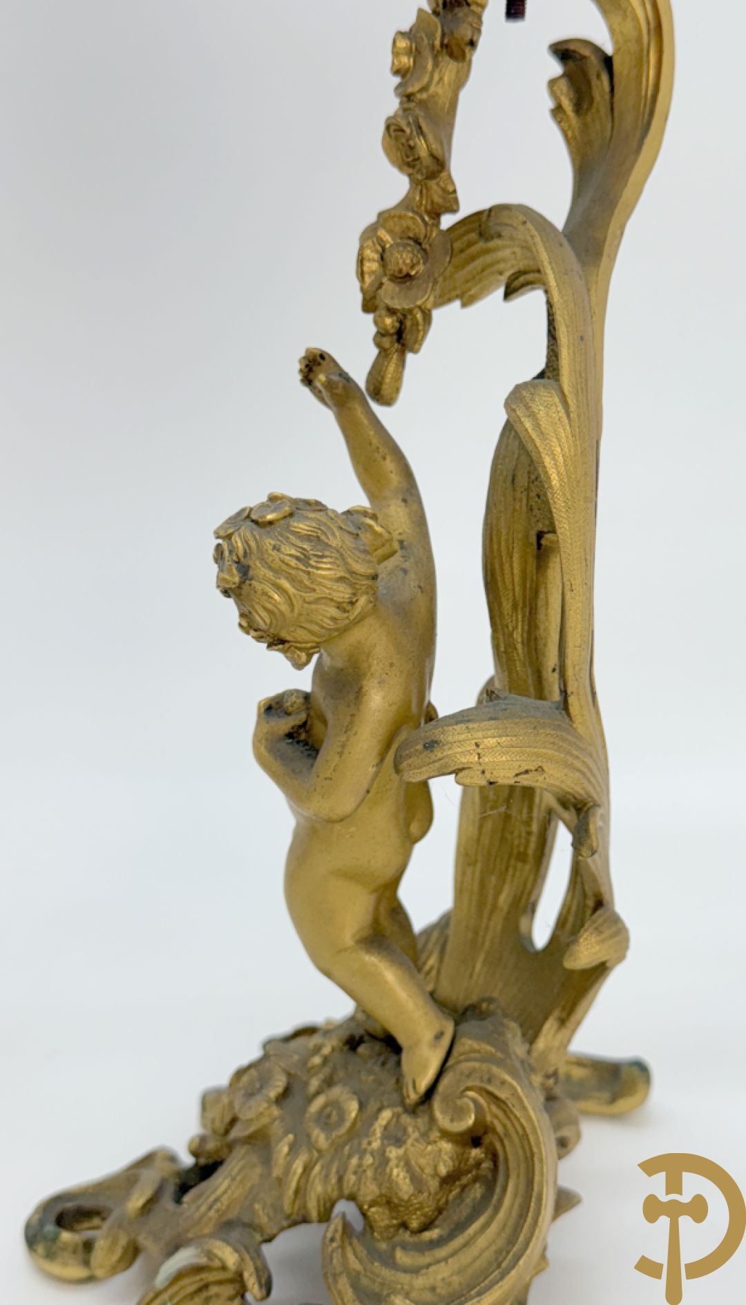 Driedelige vuurvergulde bronzen garnituur, Louis XV stijl, bestaande uit middenstuk met klok omgeven door musicerende cupido