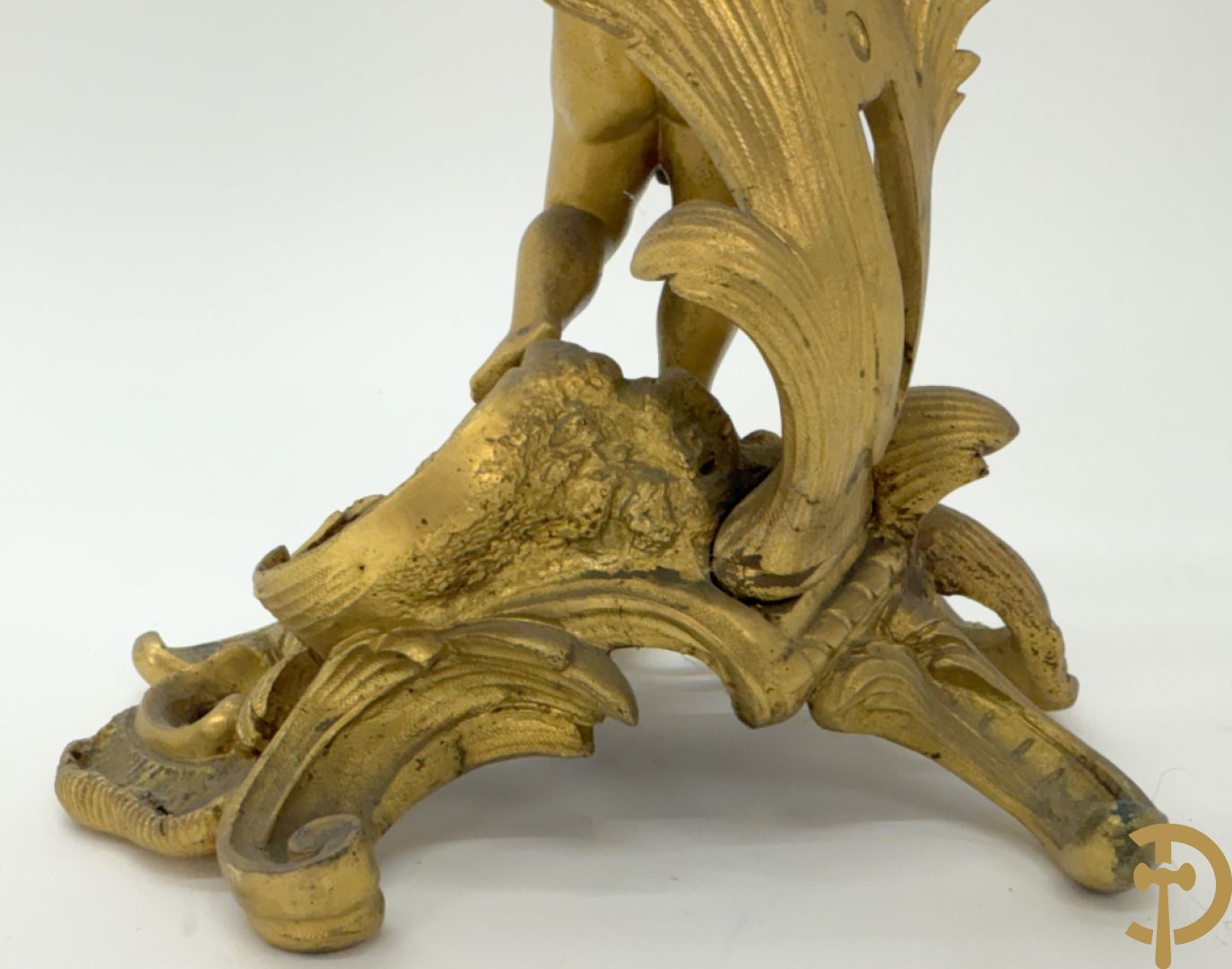 Driedelige vuurvergulde bronzen garnituur, Louis XV stijl, bestaande uit middenstuk met klok omgeven door musicerende cupido