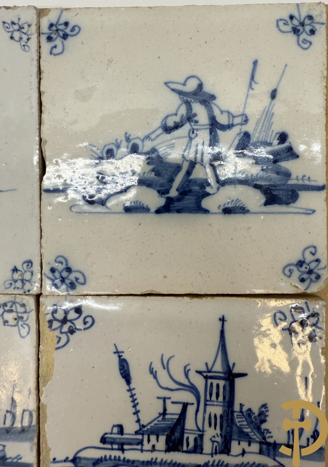 Negen Delftse tegeltjes met geanimeerd decor (6 stuks) en landschappen (3 stuks)