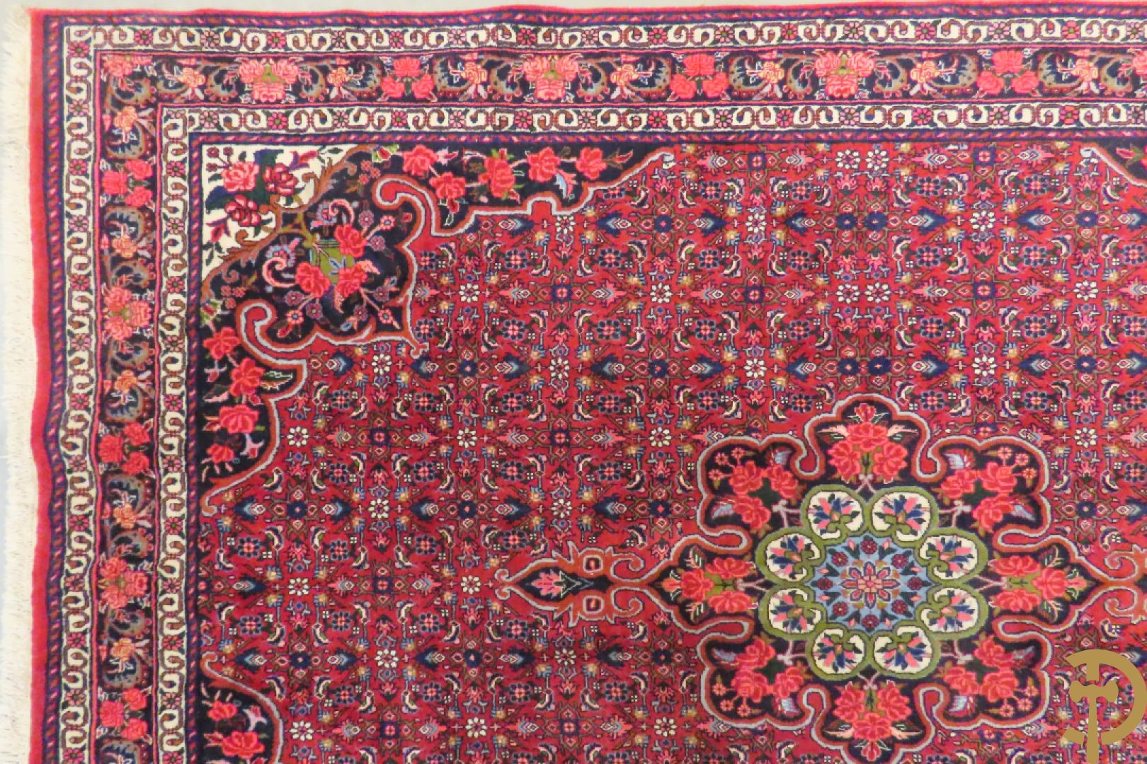 Oosters handgeknoopt tapijt met bloemenpatronen op rode fond